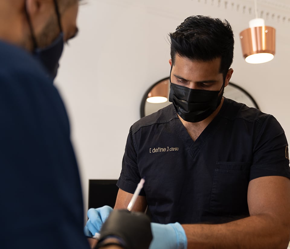 dr benji dhillon and dr kam lally performing thread lift treatment on a patient